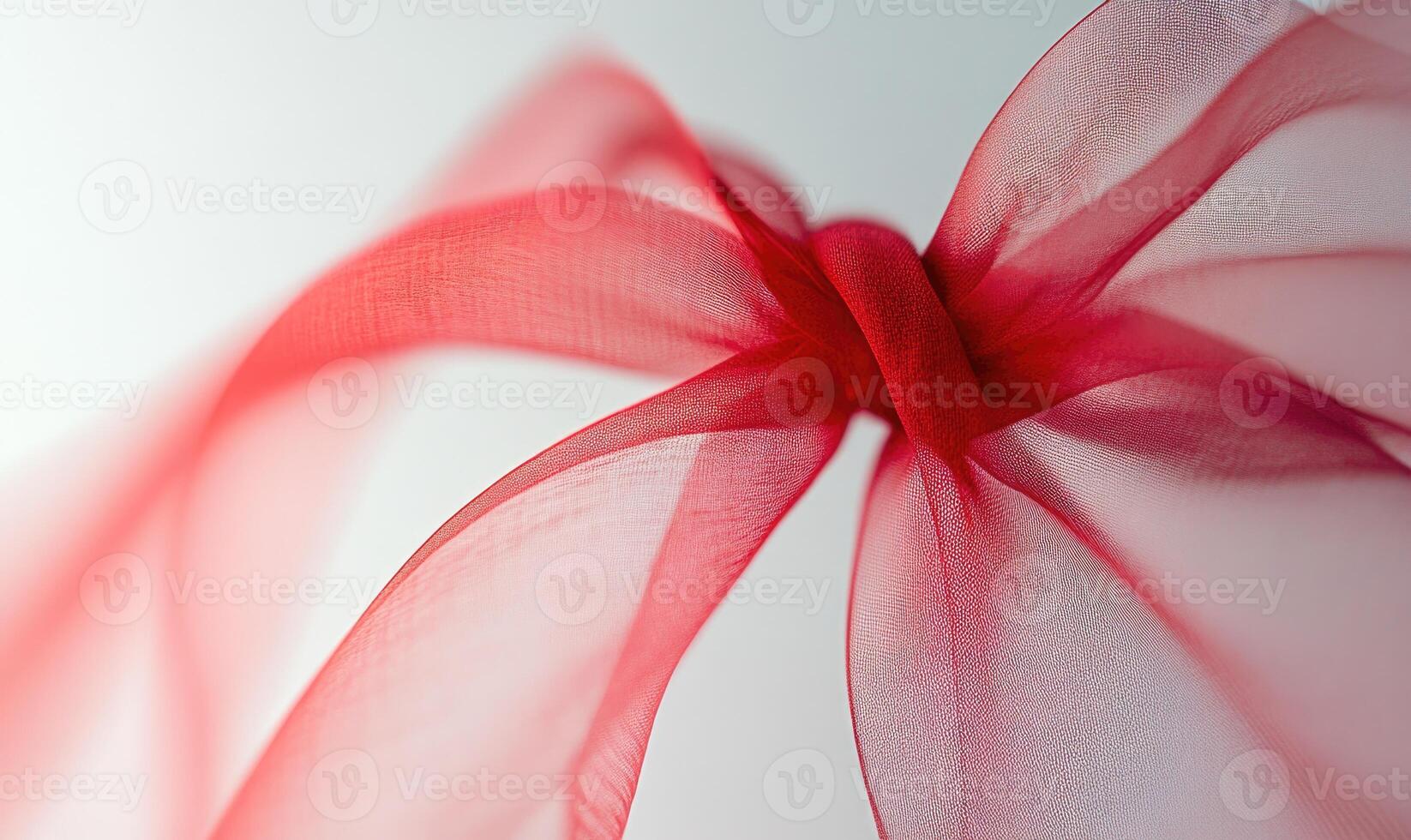 A red ribbon is shown in a close up photo