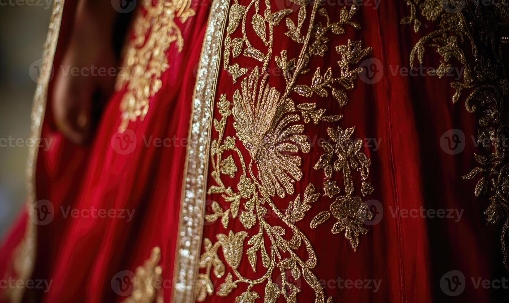 A woman is wearing a red dress with gold embroidery photo
