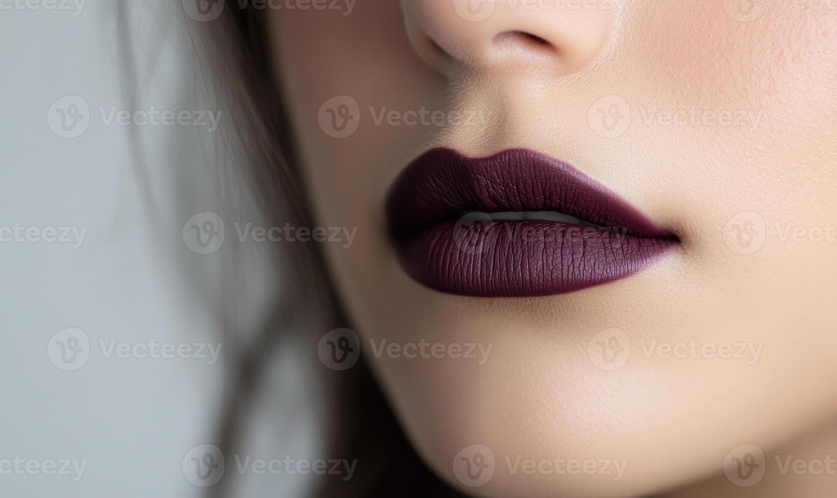 A woman with a purple lipstick is shown in a close up photo