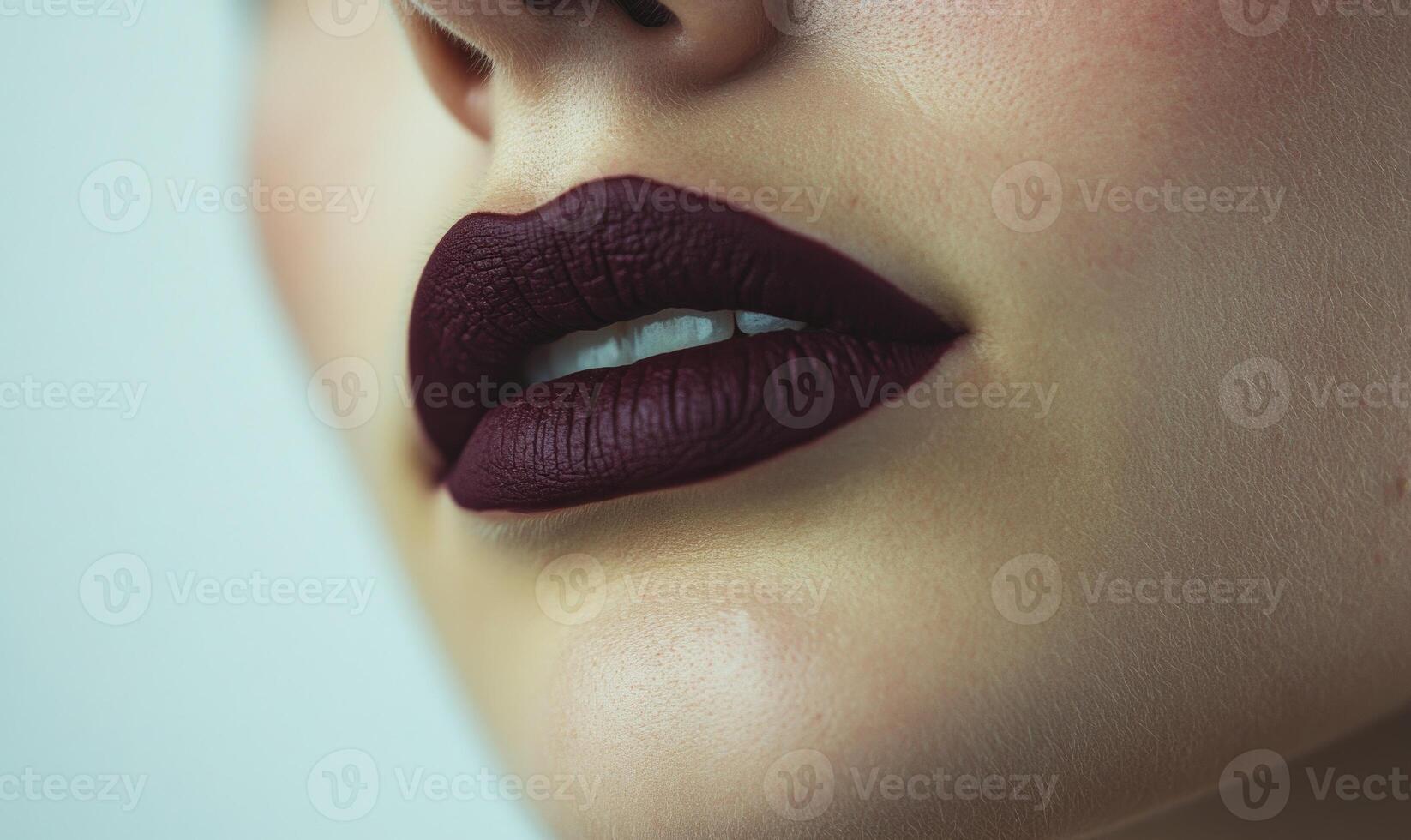 A woman's lips are painted with a deep burgundy lipstick photo