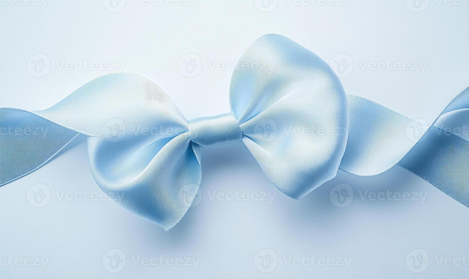 A blue ribbon with a bow is shown on a white background photo