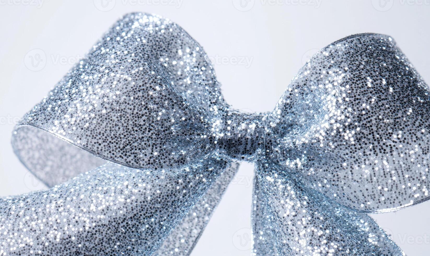 A silver ribbon with glitter is shown in a close up photo