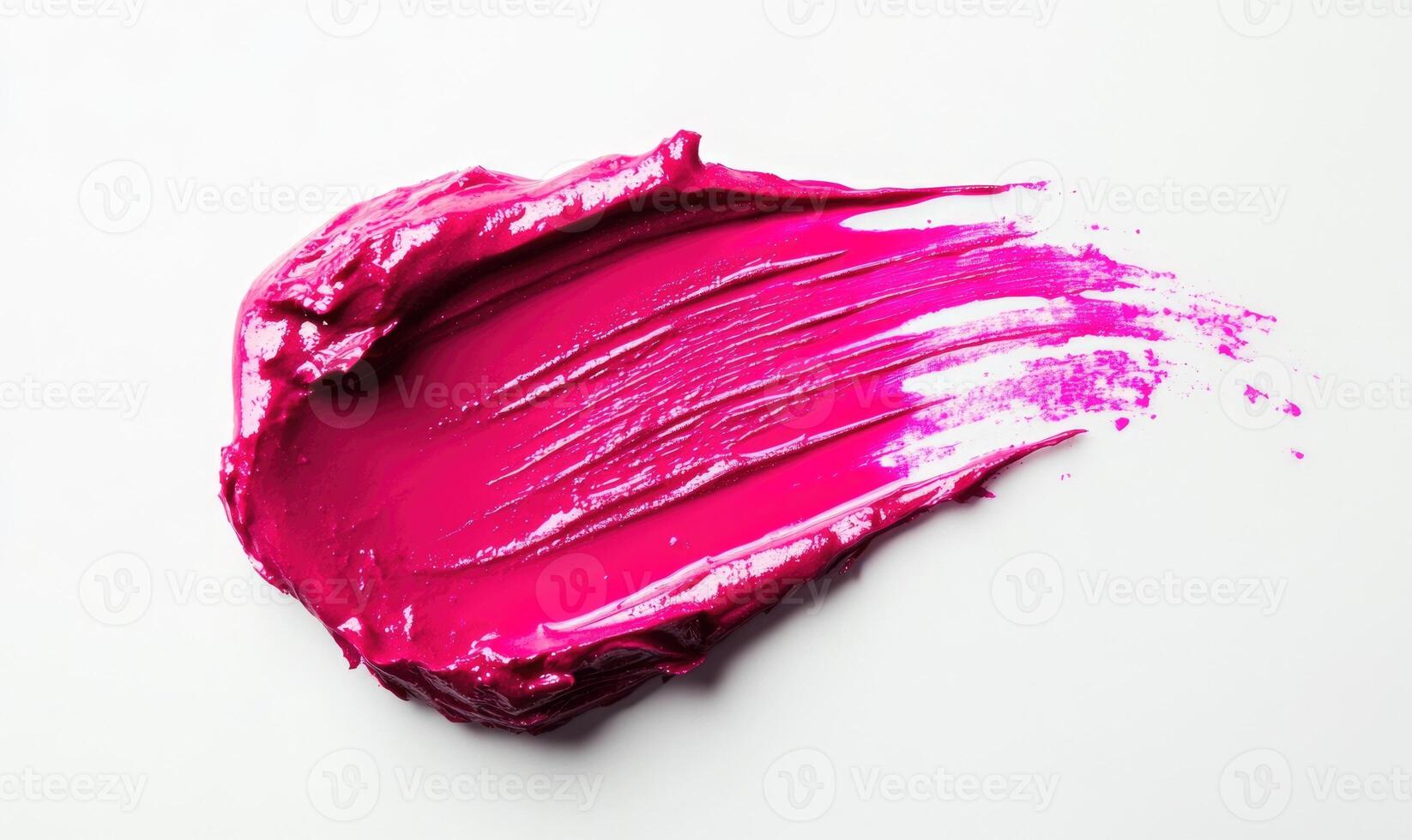 A pink lip gloss is smeared on a white background photo
