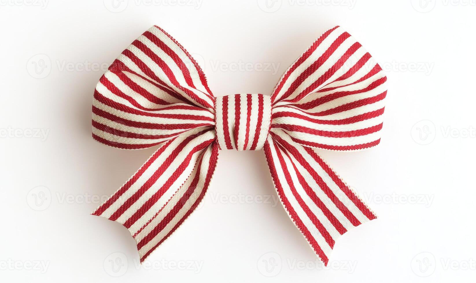 A red and white ribbon bow is sitting on a white background photo