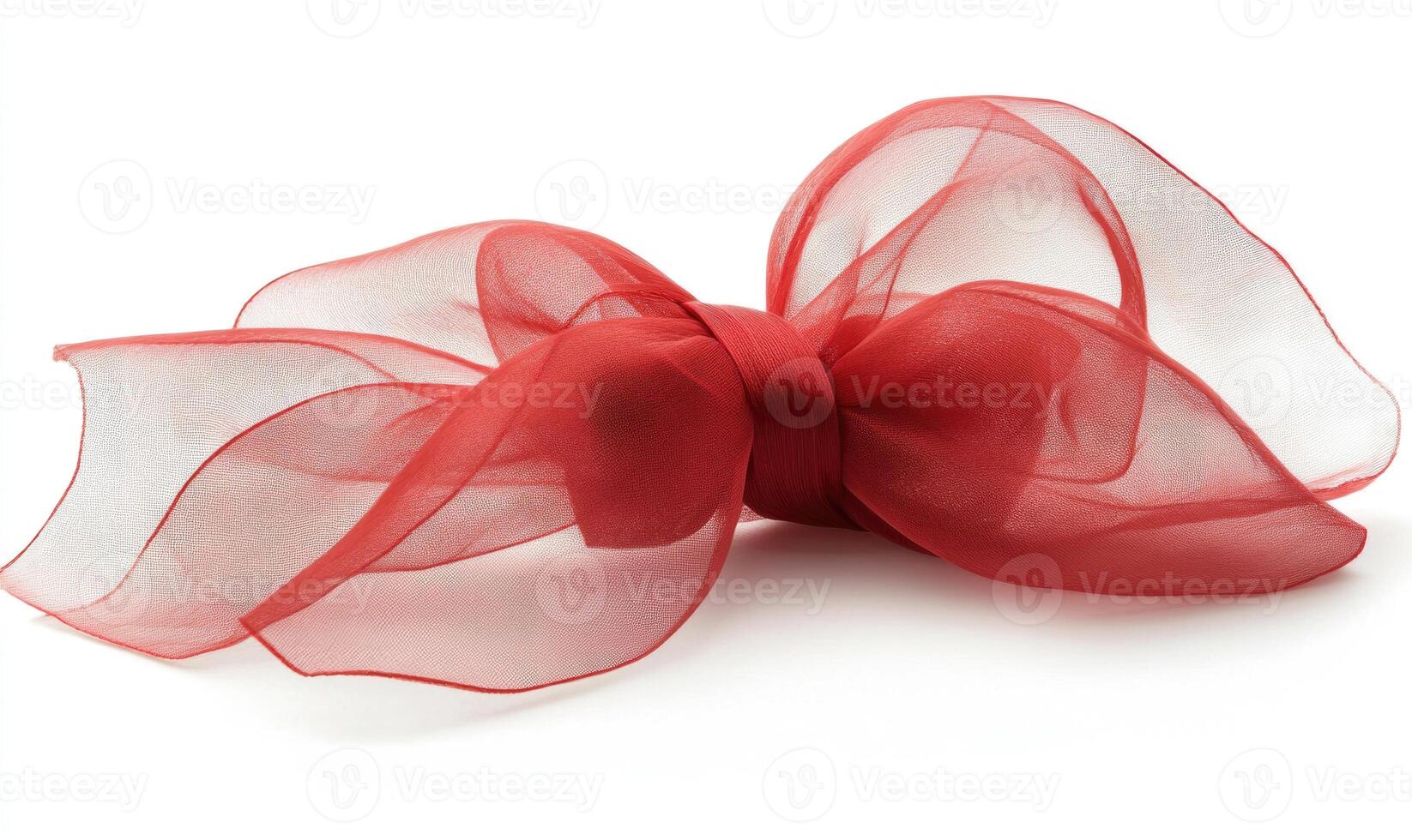 A red ribbon with a bow is laying on a white background photo