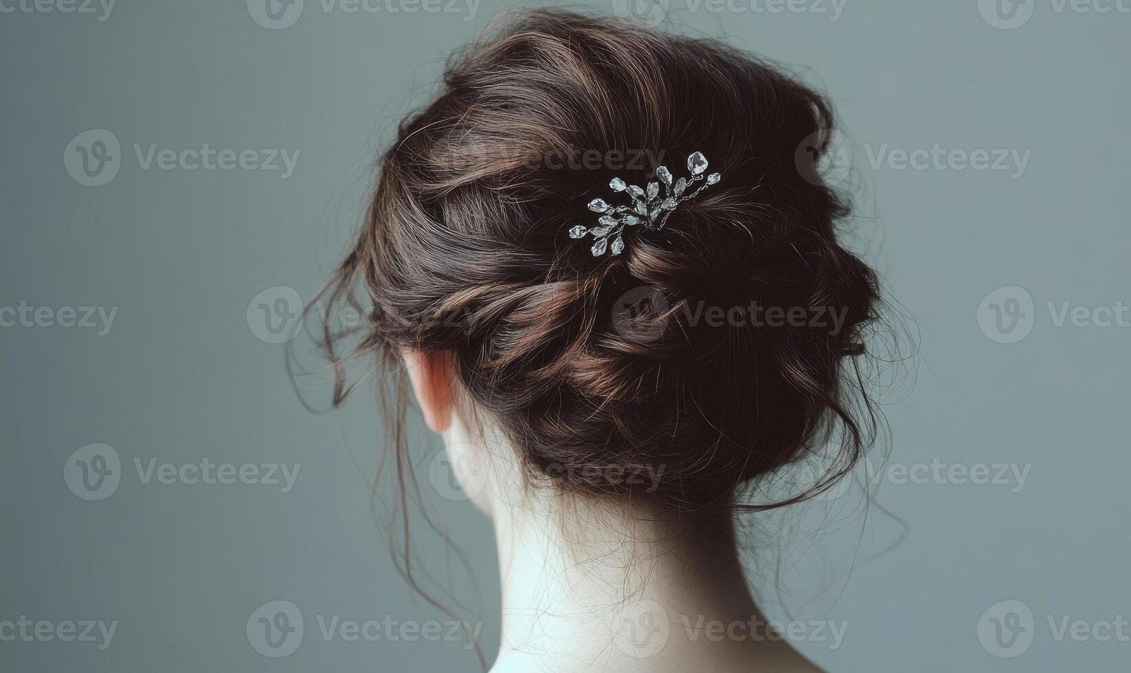 A woman with a bun in her hair and a hair clip photo