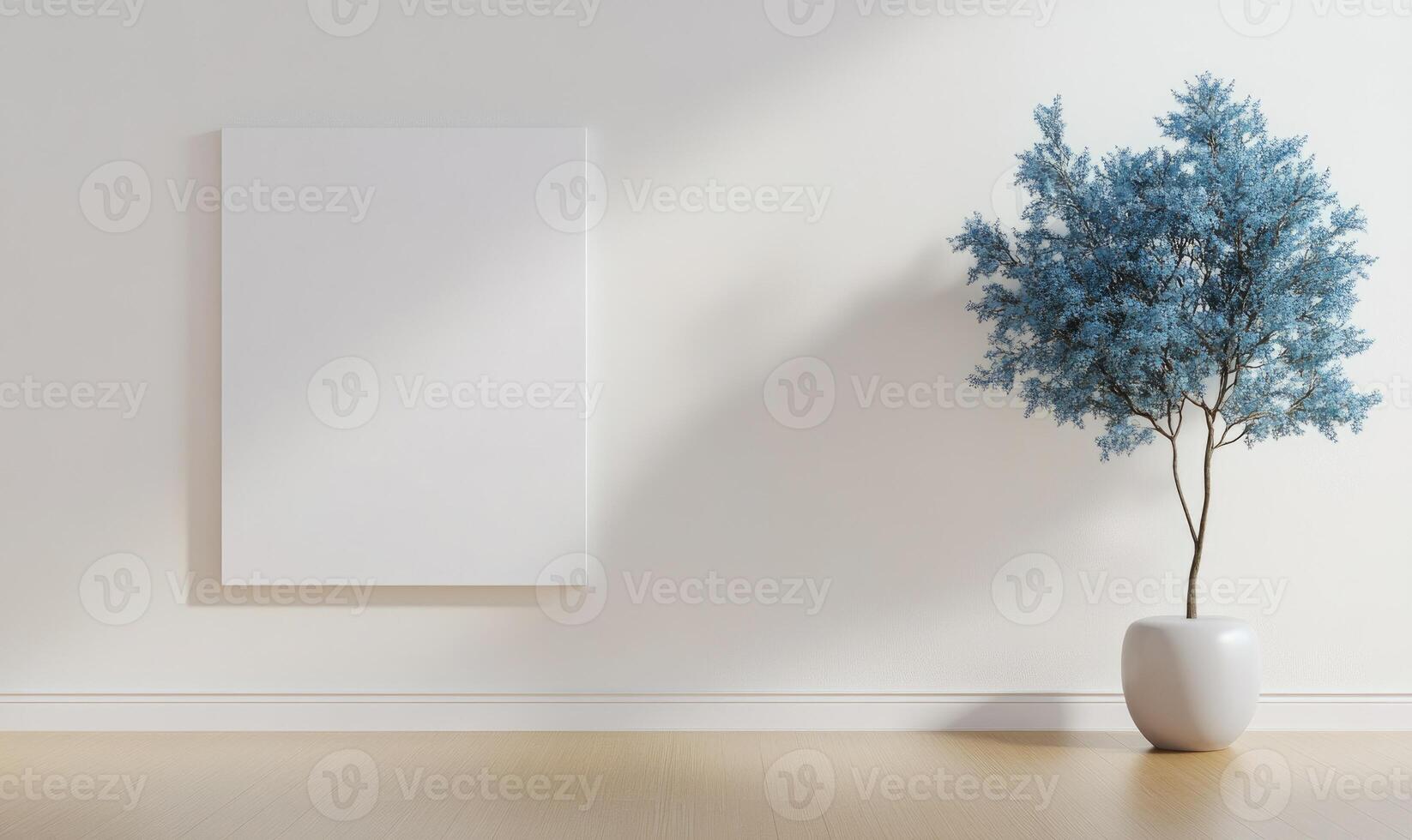 A white wall with a blue framed picture and a white vase with a blue tree in it photo