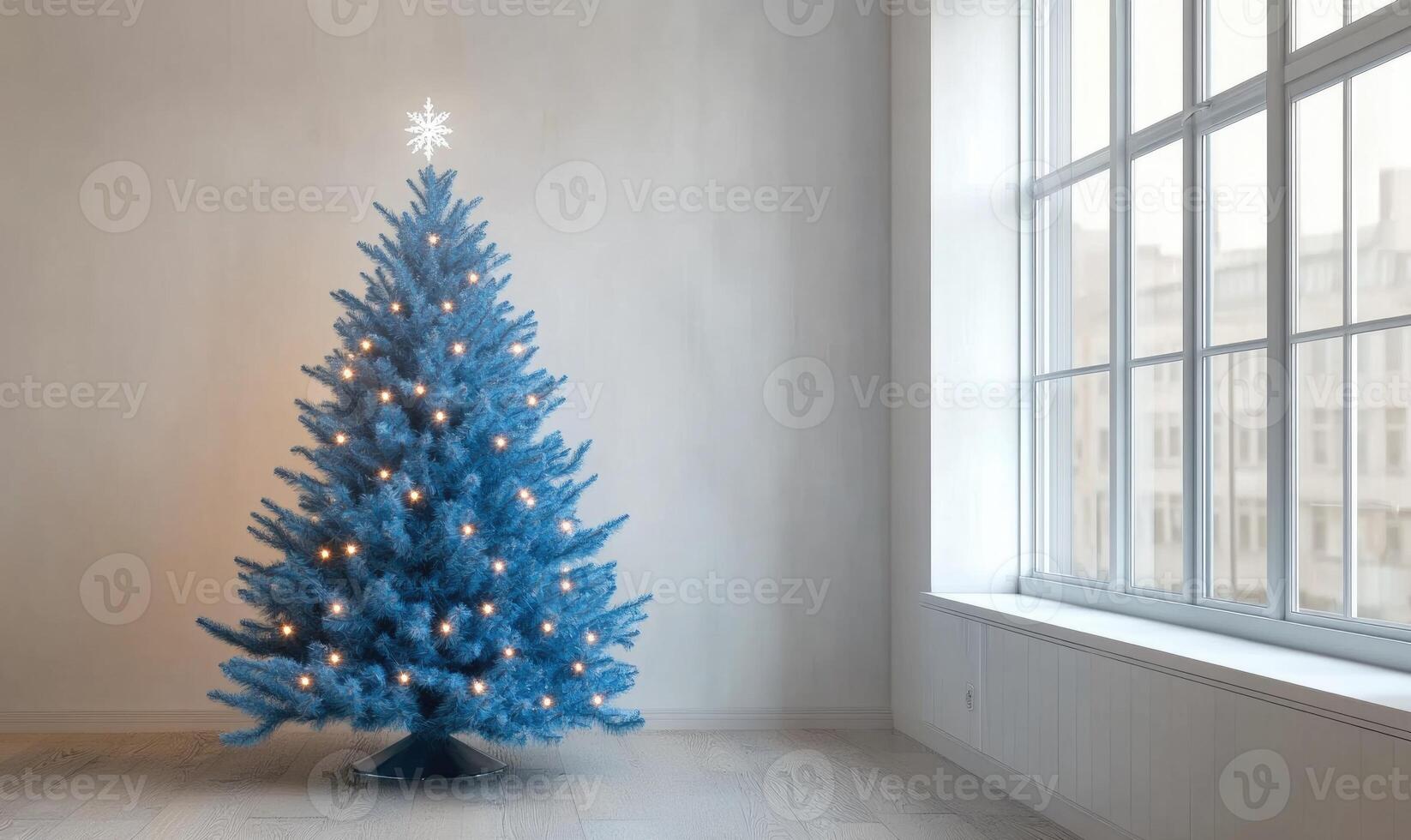 A blue Christmas tree with a snowflake on top stands in a room with a window photo