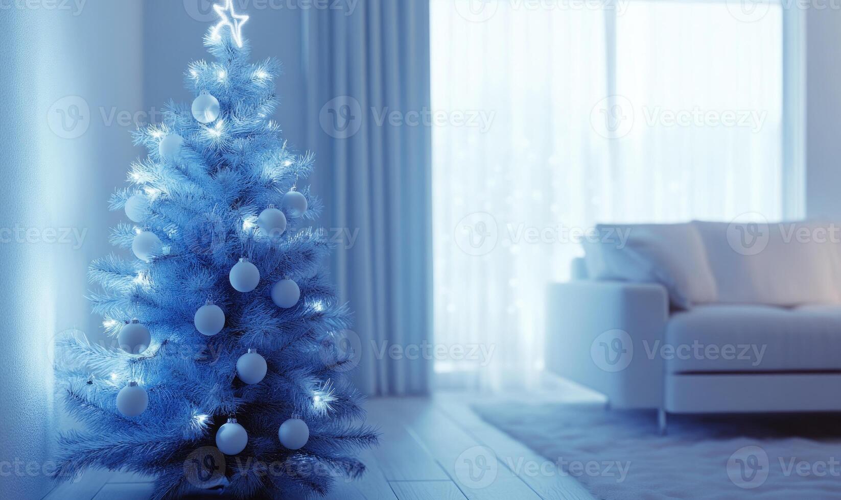 A blue Christmas tree with white ornaments sits in a living room photo