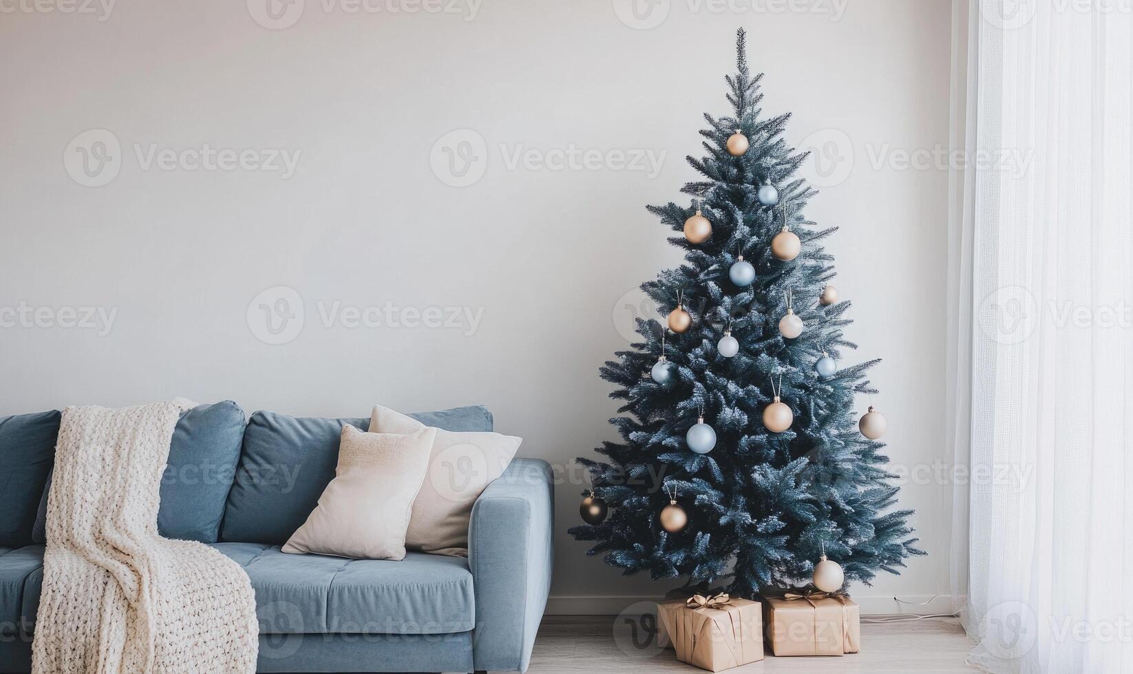 A blue couch sits next to a large Christmas tree photo