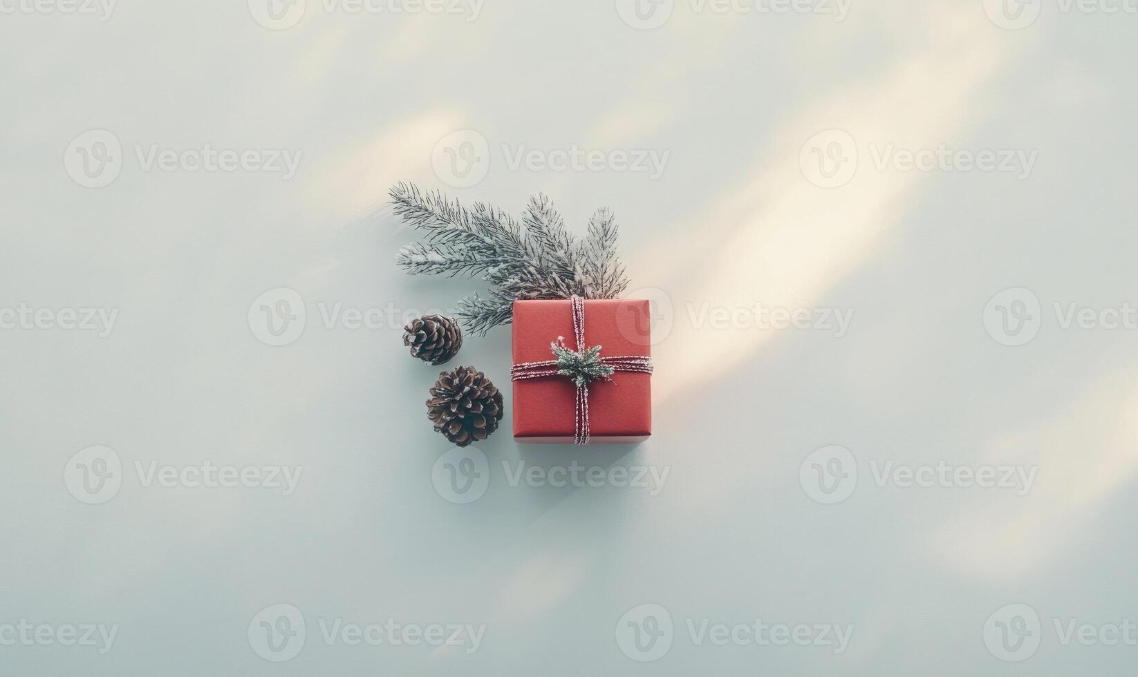 A red box with a pine cone on top of it photo