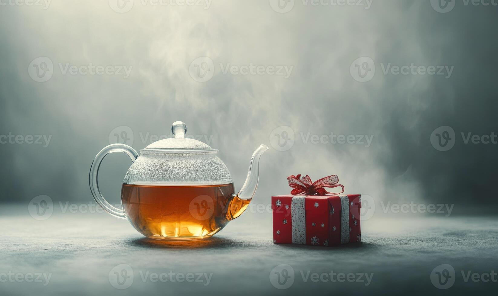A red box with a red ribbon sits next to a teapot photo