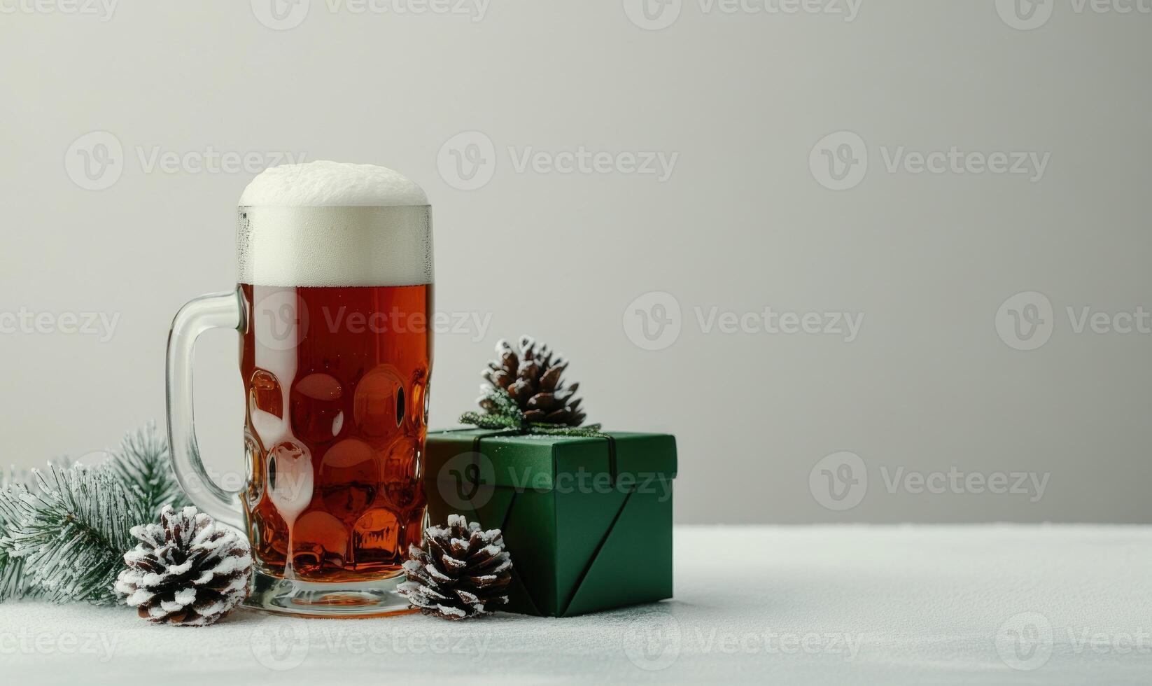 A glass of beer is on a table next to a green box photo