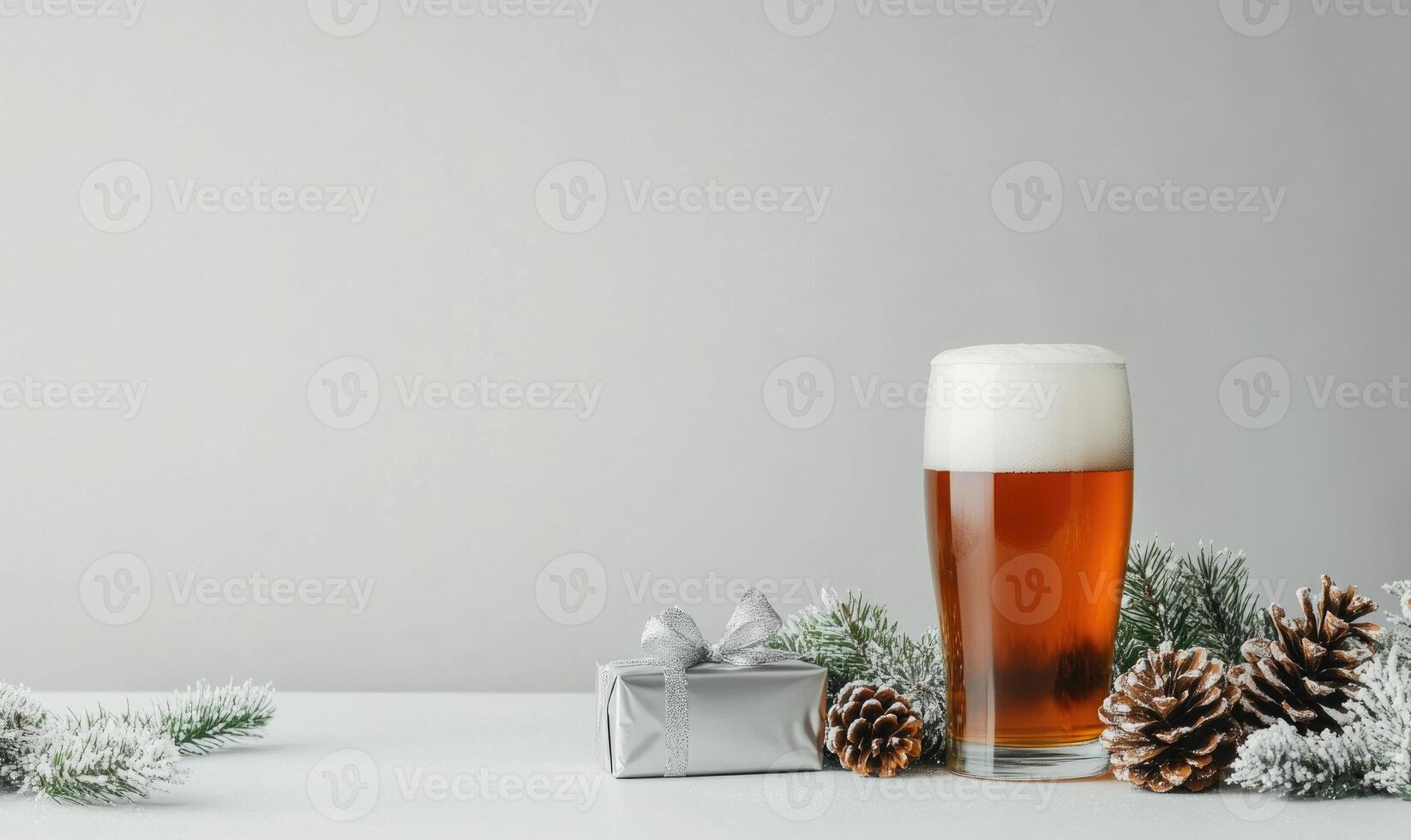 A glass of beer sits on a table next to a gift box photo