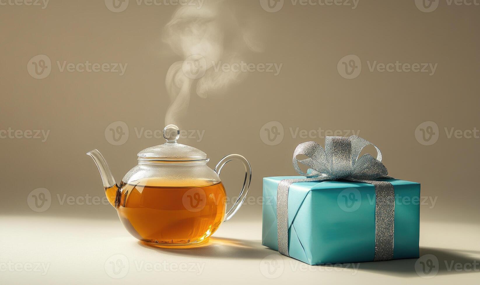 A teapot with steam coming out of it sits next to a blue box photo