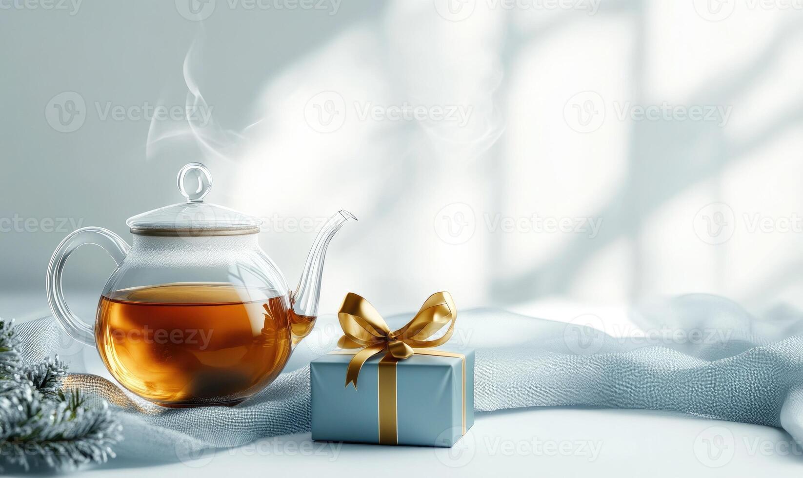 A tea kettle is sitting on a table next to a blue box with a gold ribbon photo