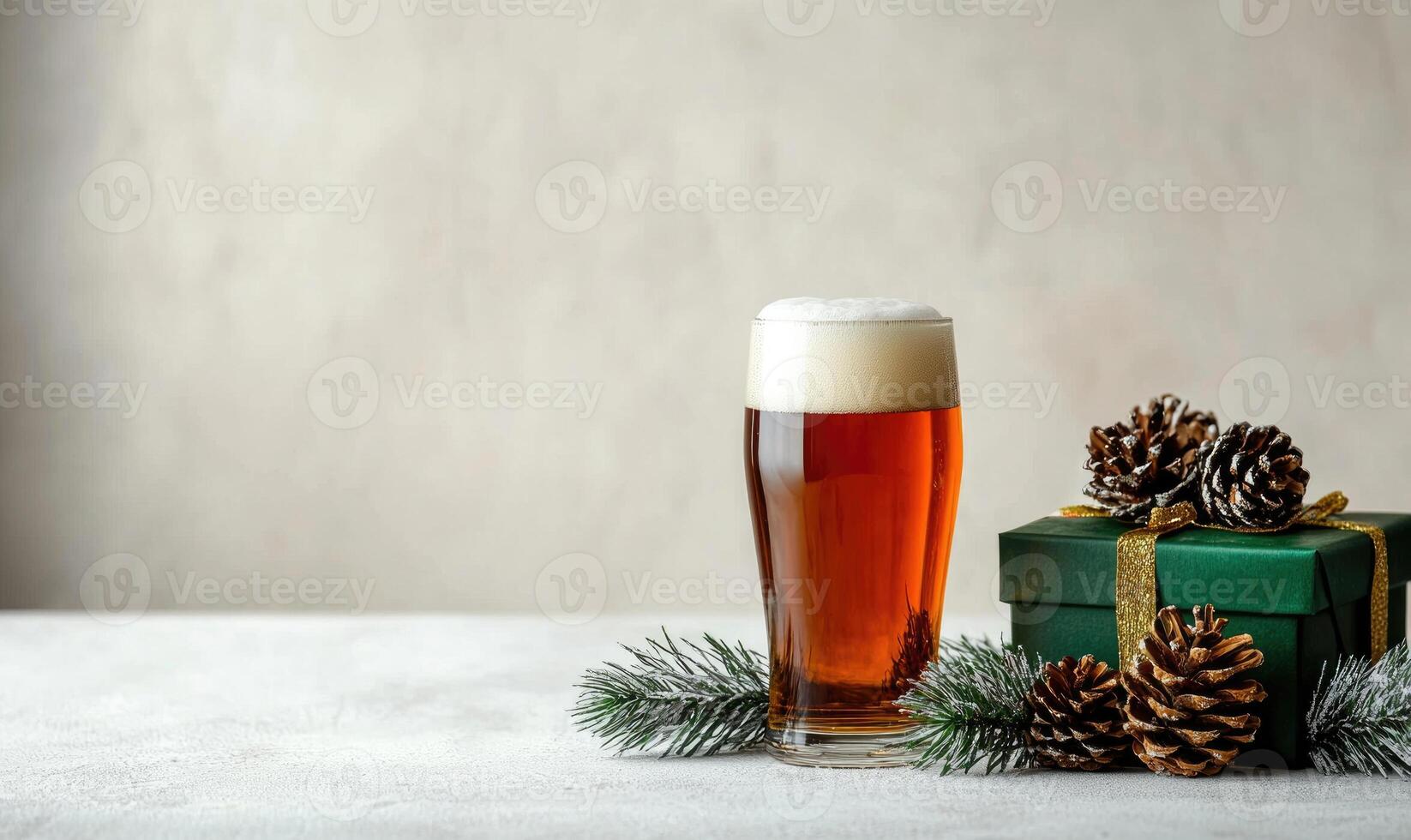 A glass of beer sits on a table next to a green box photo