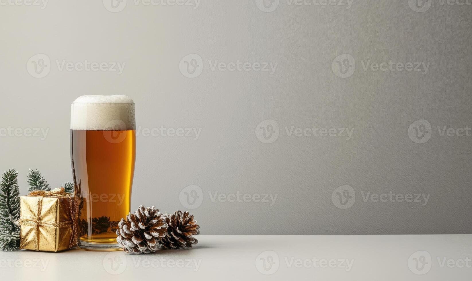 A glass of beer is on a table with pine cones and a gold box photo