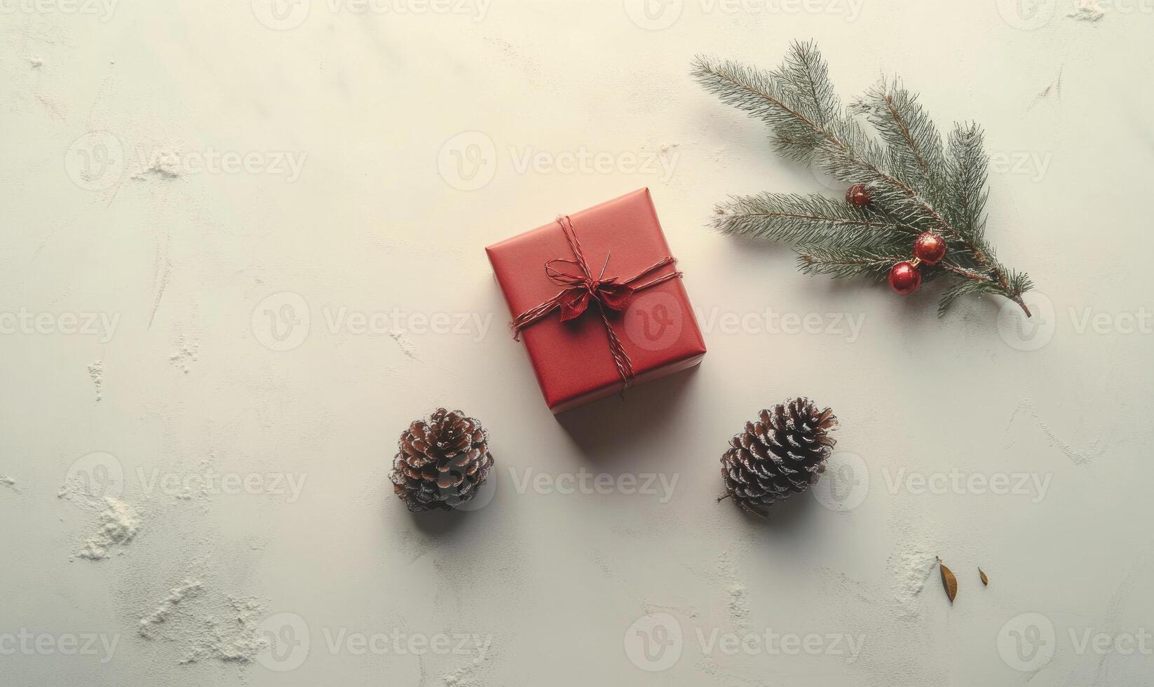 A red box with a bow on top sits on a white background photo