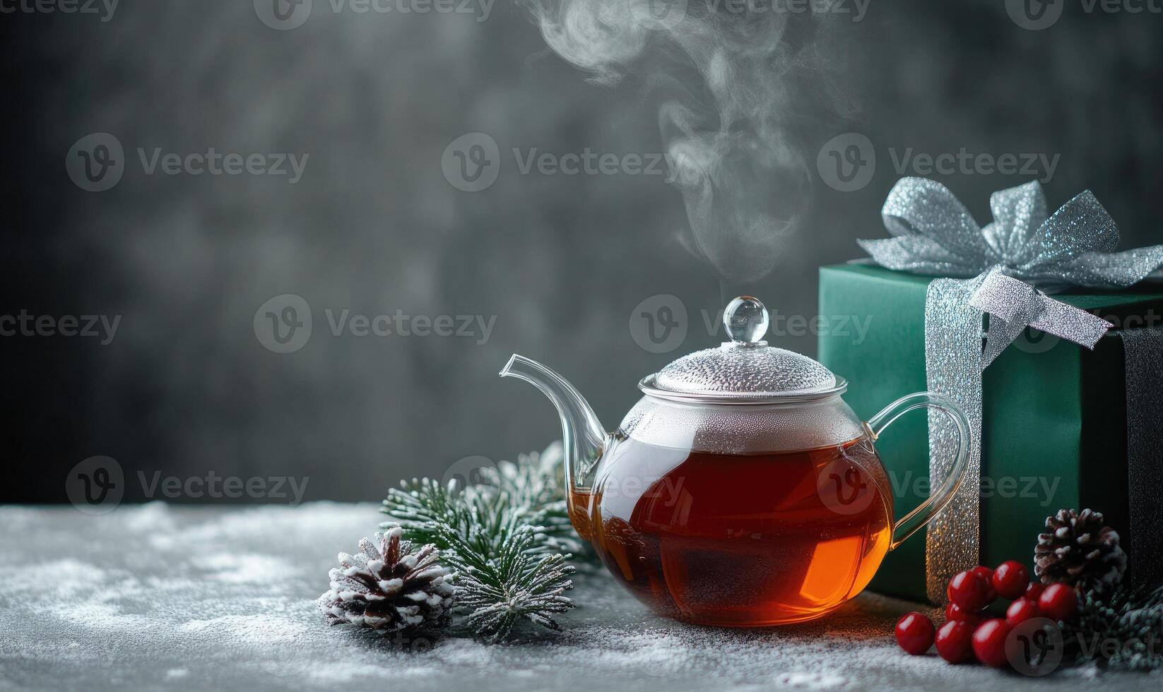 A green tea kettle sits on a table next to a green box photo