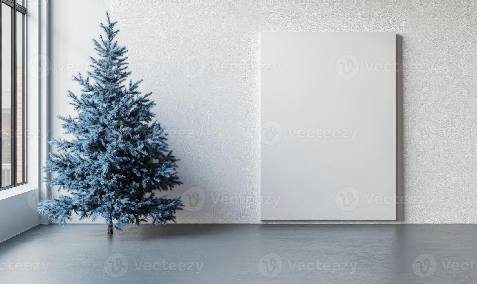 A blue Christmas tree stands in front of a white wall photo