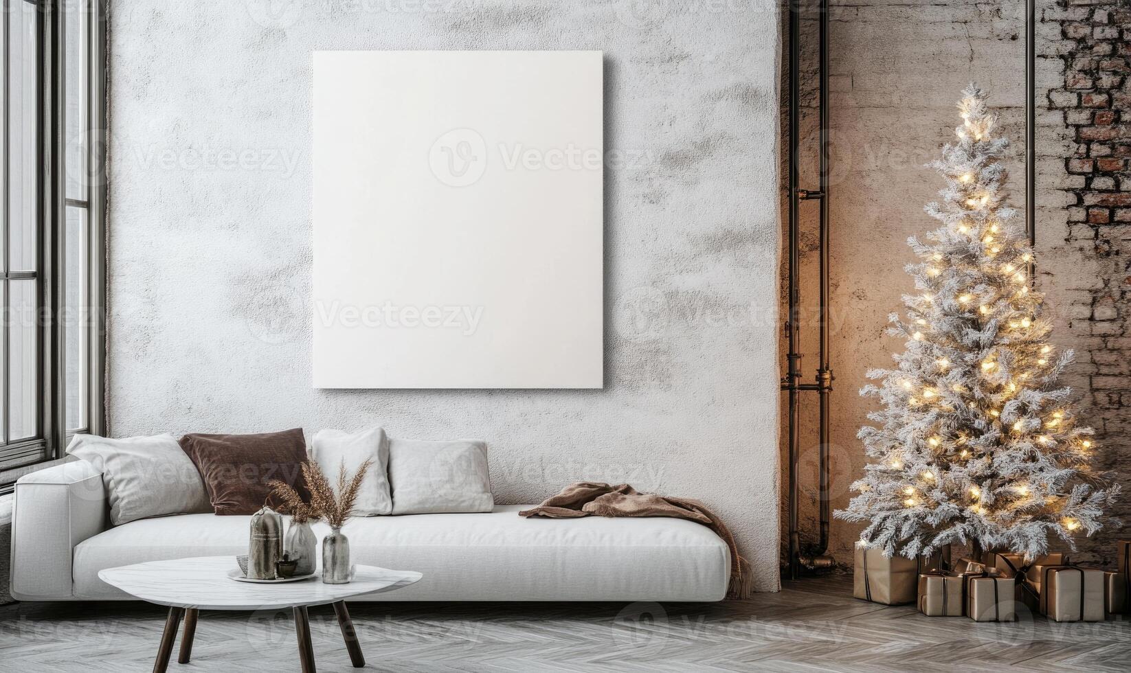 A white Christmas tree sits in front of a white wall with a white picture frame photo