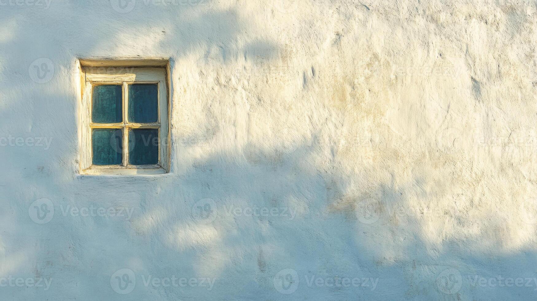 A Single Window on a White Wall with Shadowy Details photo