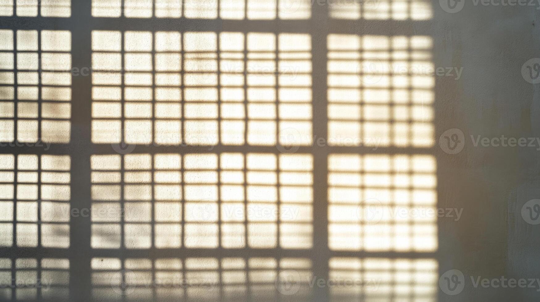 Gridded Window Shadow on a Light-Colored Wall photo