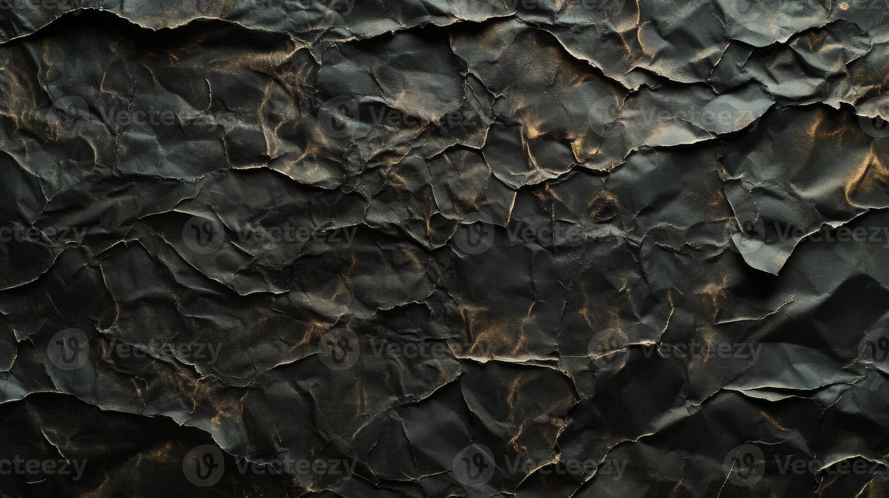 Crumpled Black Paper With Golden Highlights photo