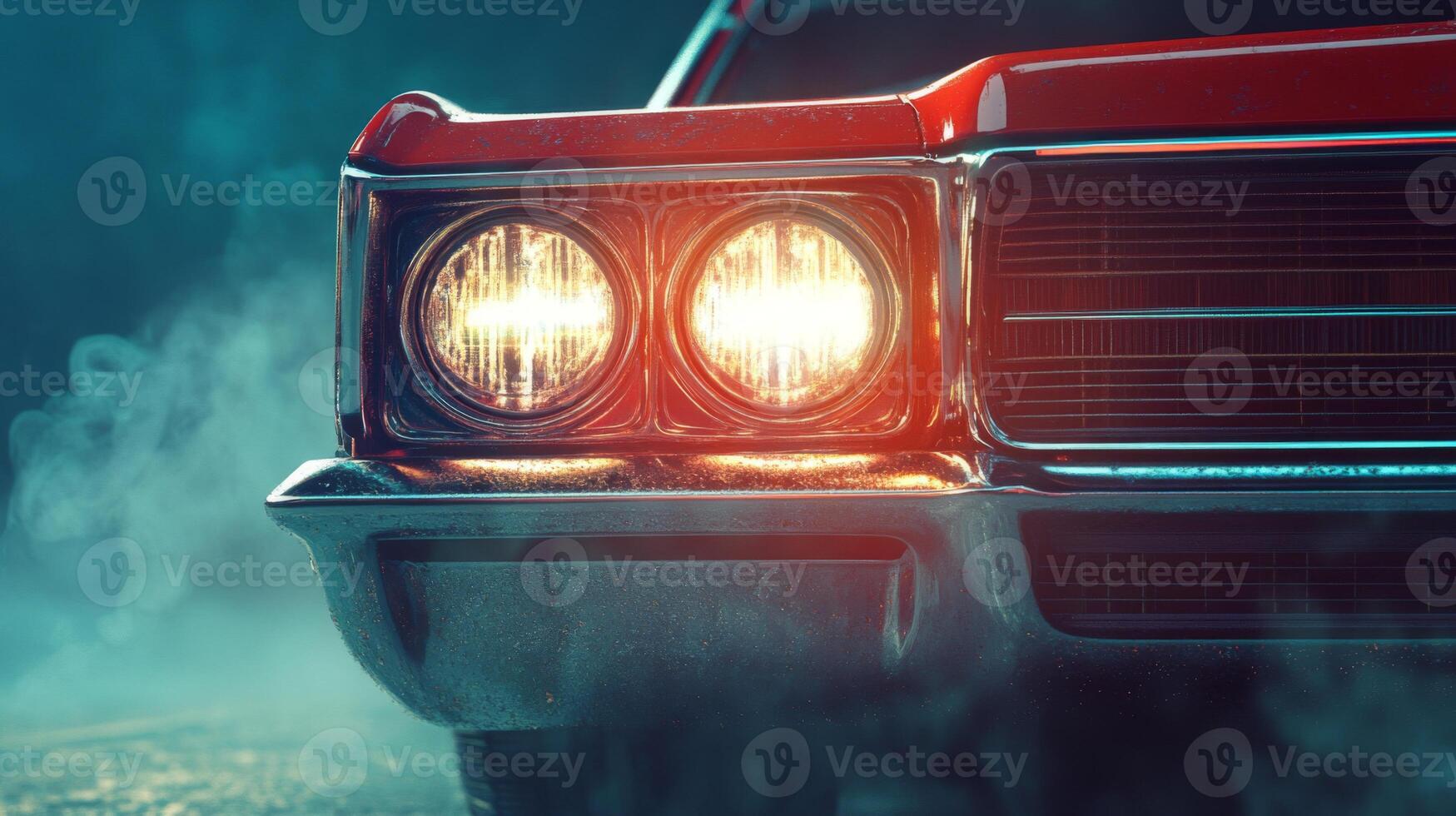 Close-up of a Classic Red Car's Front End with Headlights On and Smoke photo