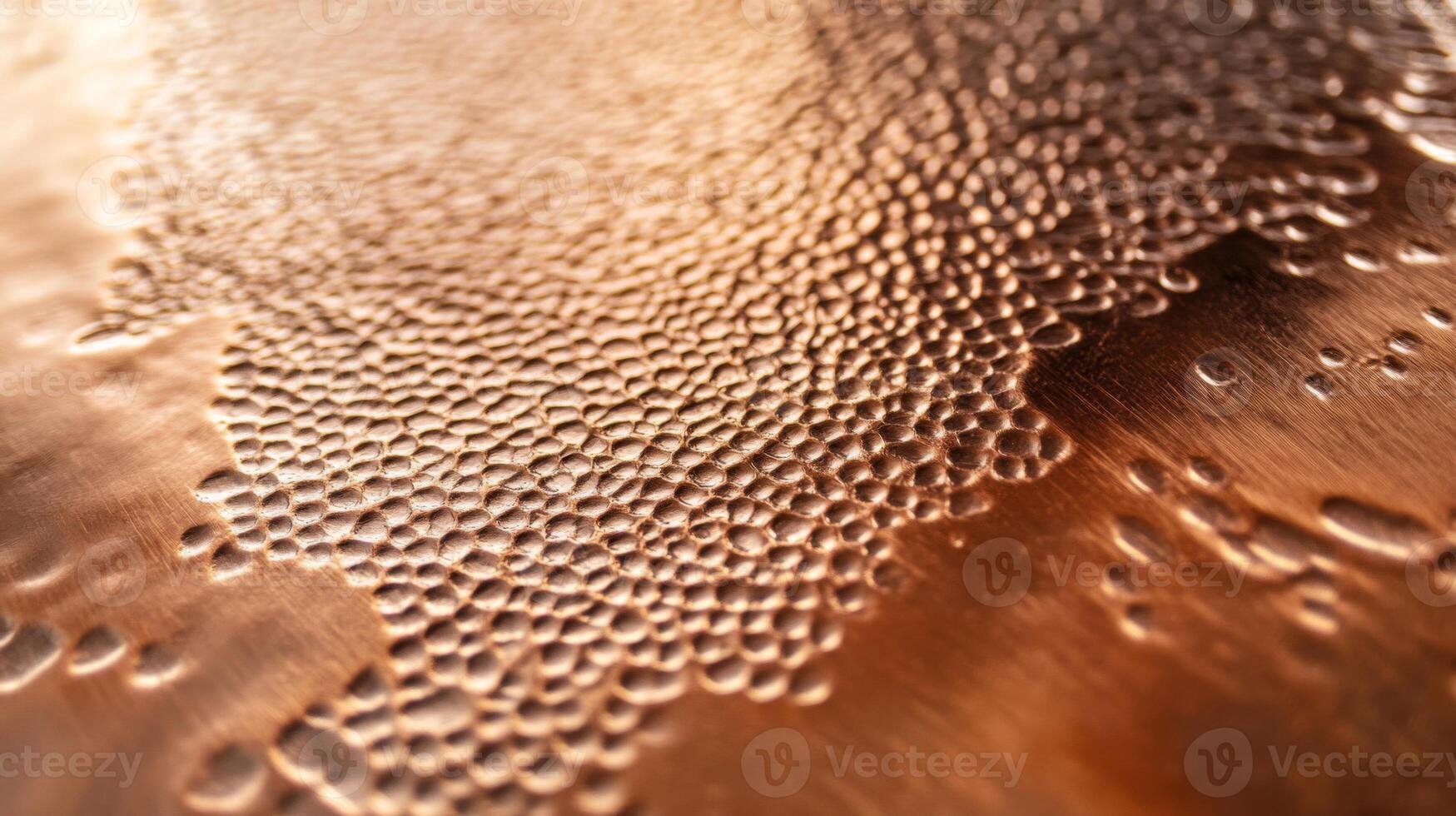 Close-up of a Copper Surface with a Pattern of Small, Round Indents photo