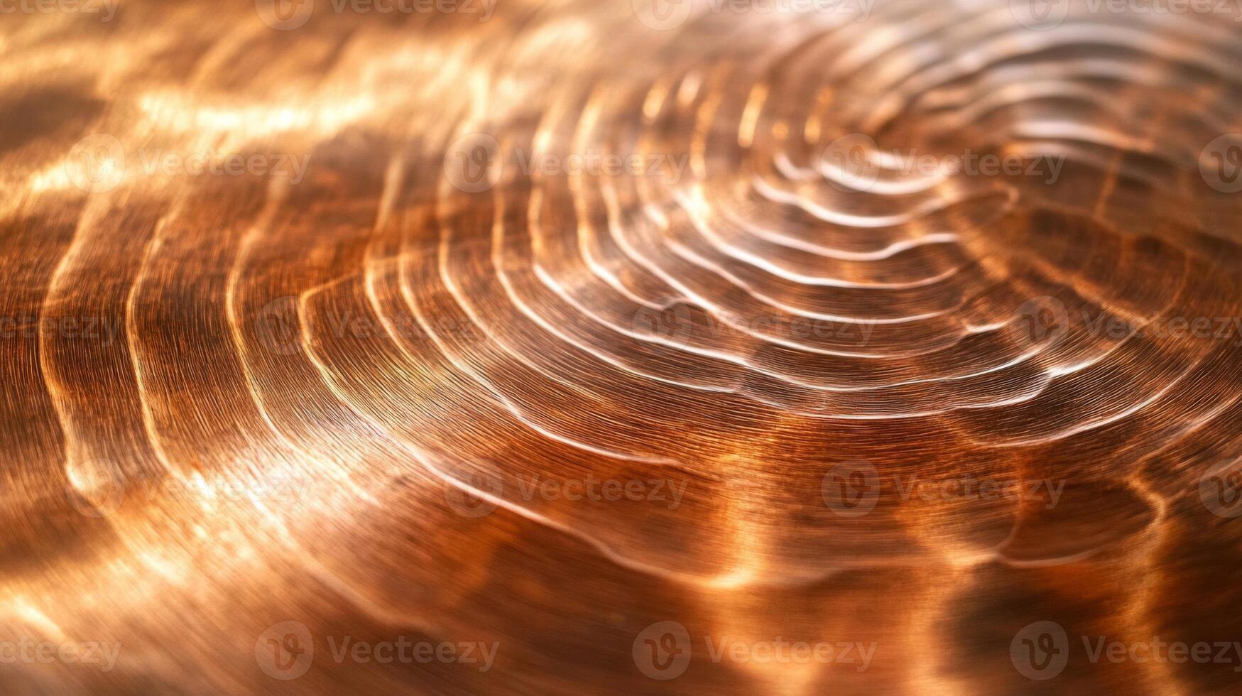 Close-up of a Shiny Copper Surface with Circular Patterns photo