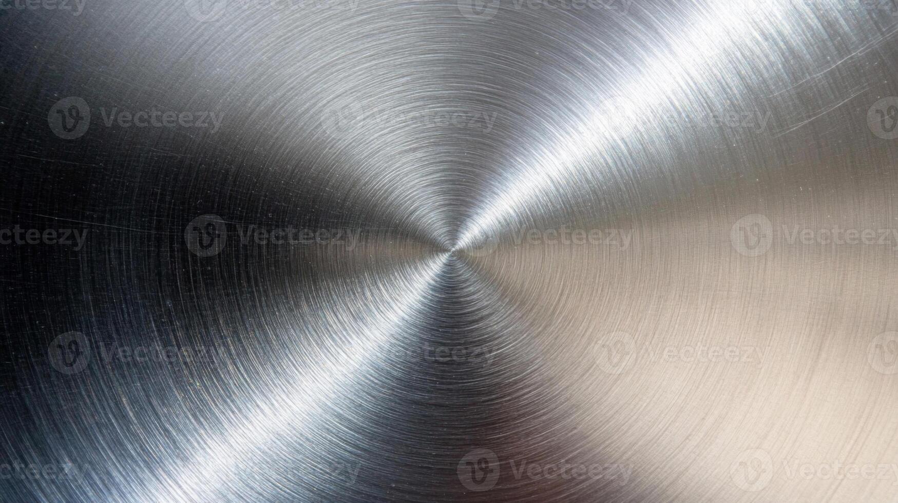 A Circular Pattern of Light on a Brushed Metal Surface photo