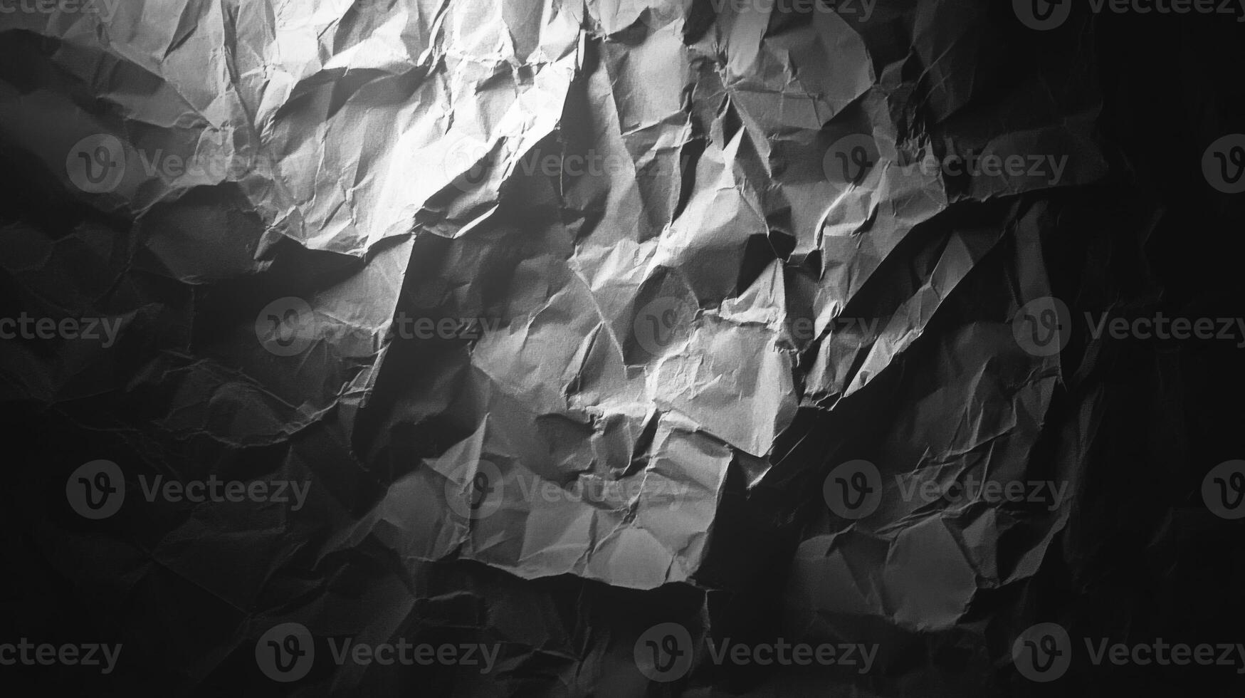 A Close-Up of a Crumpled, Textured Black Paper Surface photo