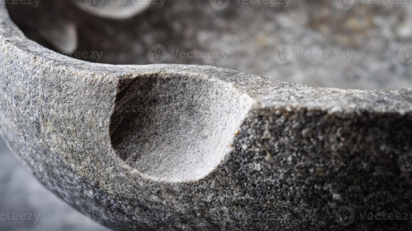 Close-up of a Rough Stone Mortar with a Deep Indentation photo