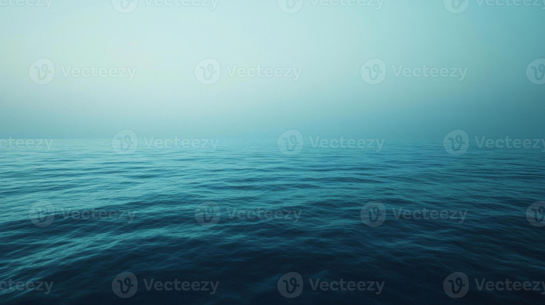 Calm Ocean Surface with Misty Sky photo