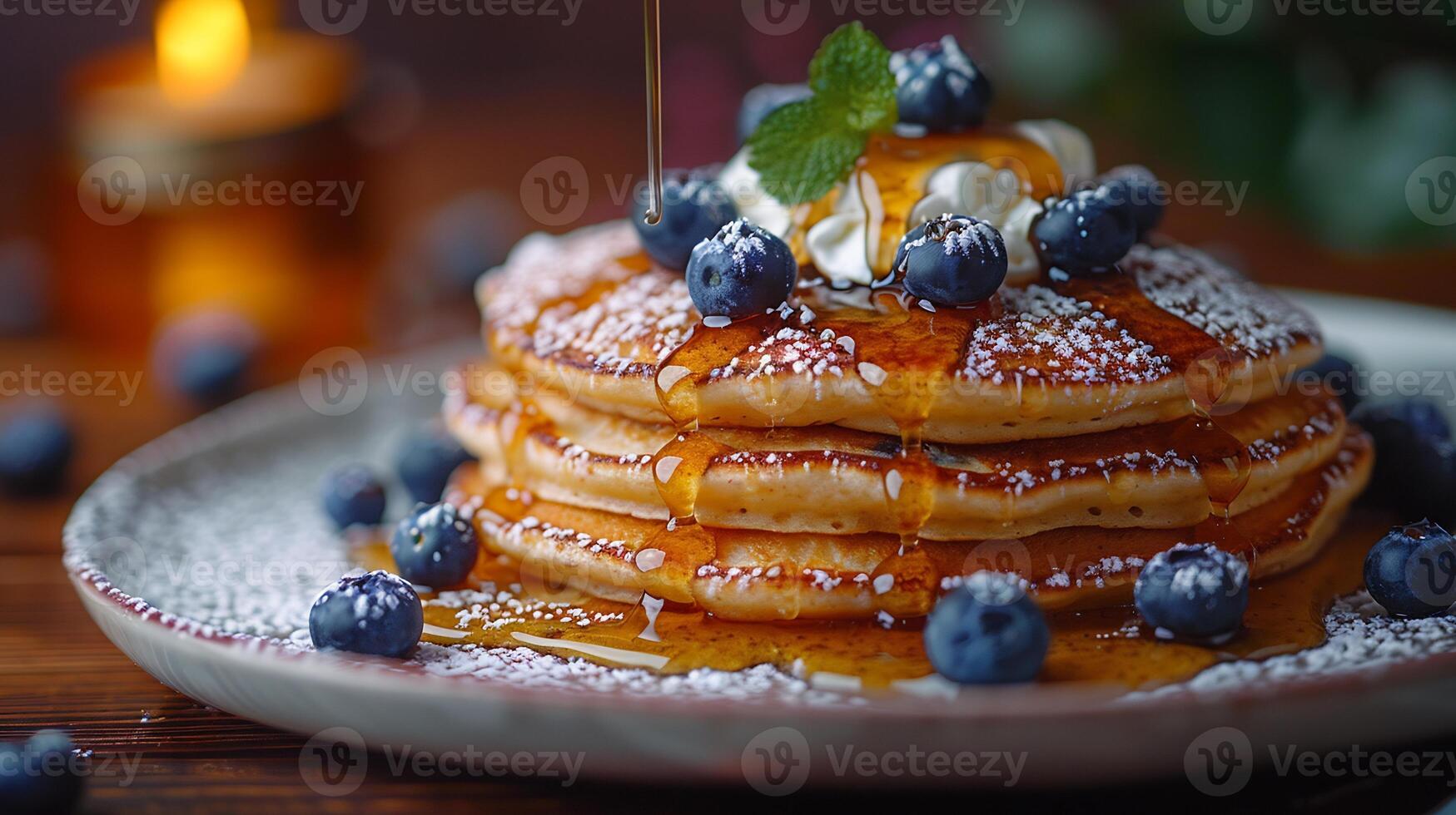 Creative breakfast scene with a stack of fluffy pancakes recipe topped with fresh blueberries a dollop of whipped cream and a generous drizzle of maple syrup cascading down the sides photo