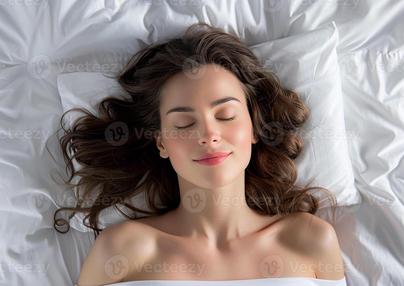 Top view of a serene young woman lying in bed, comfortably asleep photo