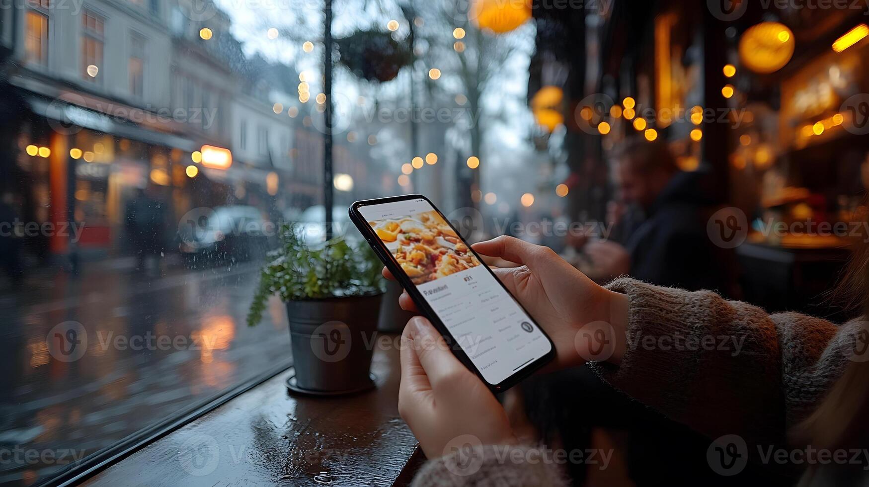 Close-up of hands holding smartphone to save customer menu order, photo