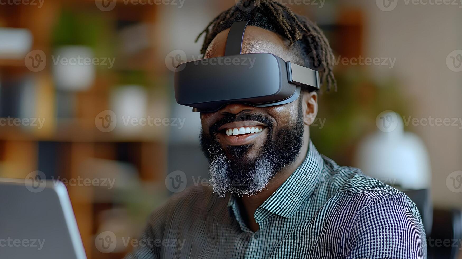 Business professional with a big smile, using virtual reality goggles at his office desk, gesturing as he navigates a digital world. photo