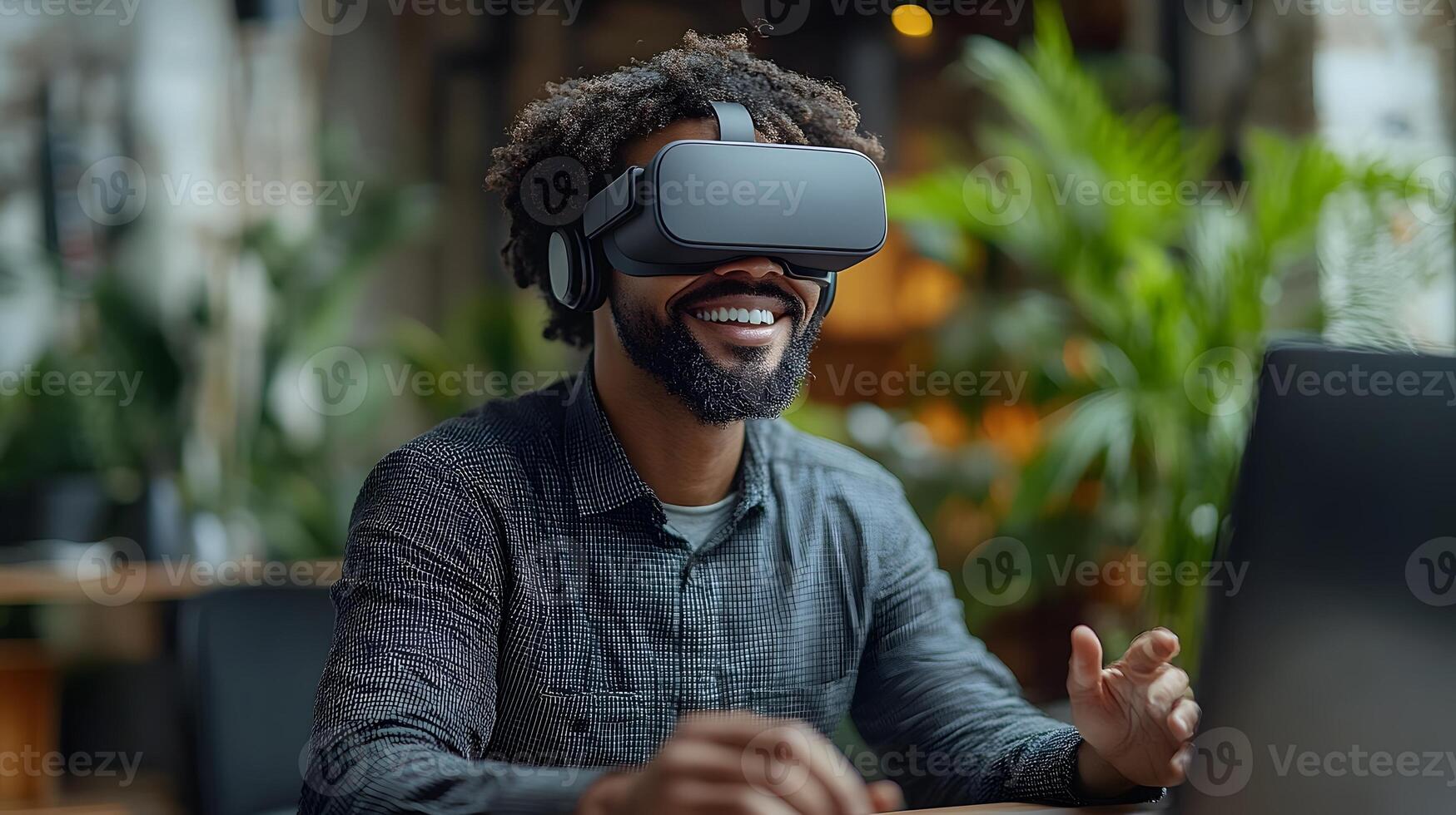 Business professional with a big smile, using virtual reality goggles at his office desk, gesturing as he navigates a digital world. photo