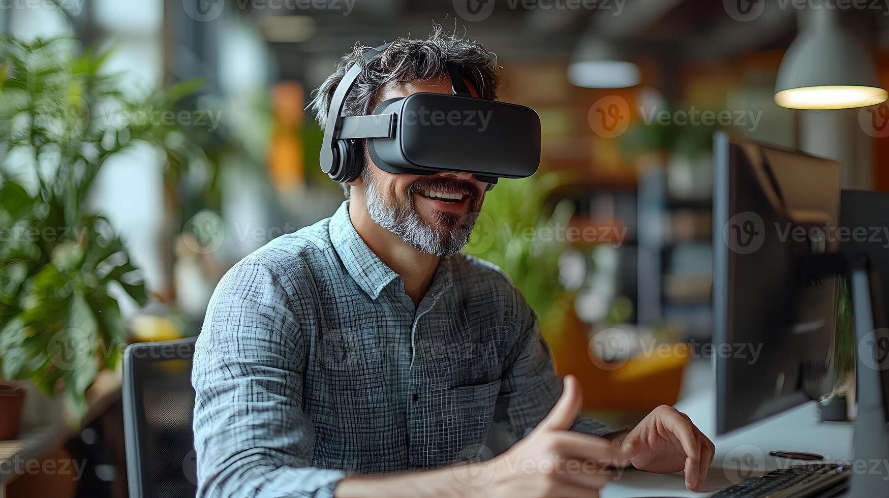 Smiling professional man at his desk, using virtual reality goggles to explore a digital world, making dynamic hand movements in a modern office. photo