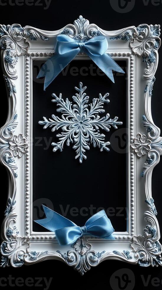 White ornate picture frame decorated with blue ribbons and snowflakes for christmas photo