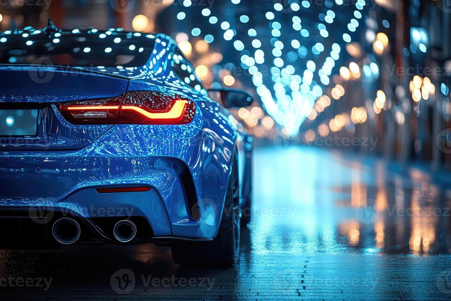 Blue sports car parked in a city at night reflecting city lights photo