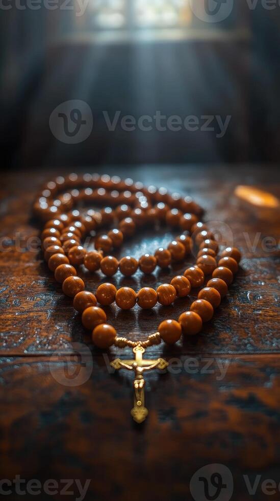 Wooden rosary beads with silver crucifix resting on tabletop photo