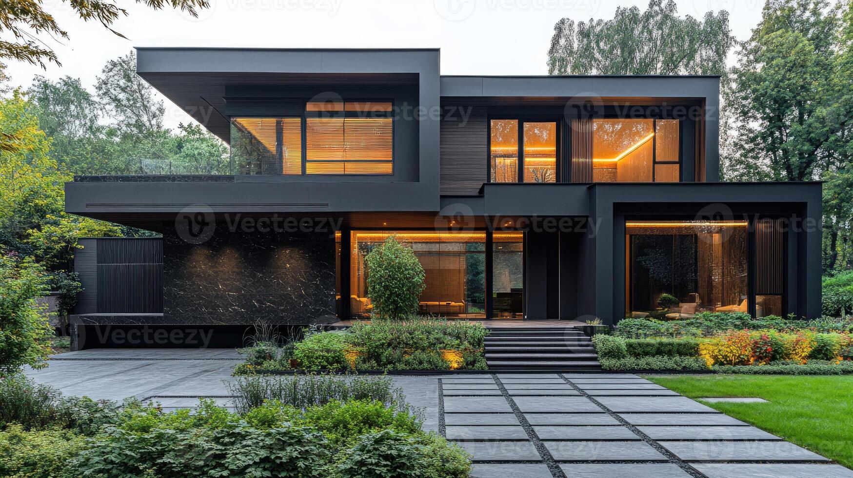 Modern house exterior with glowing windows at dusk photo