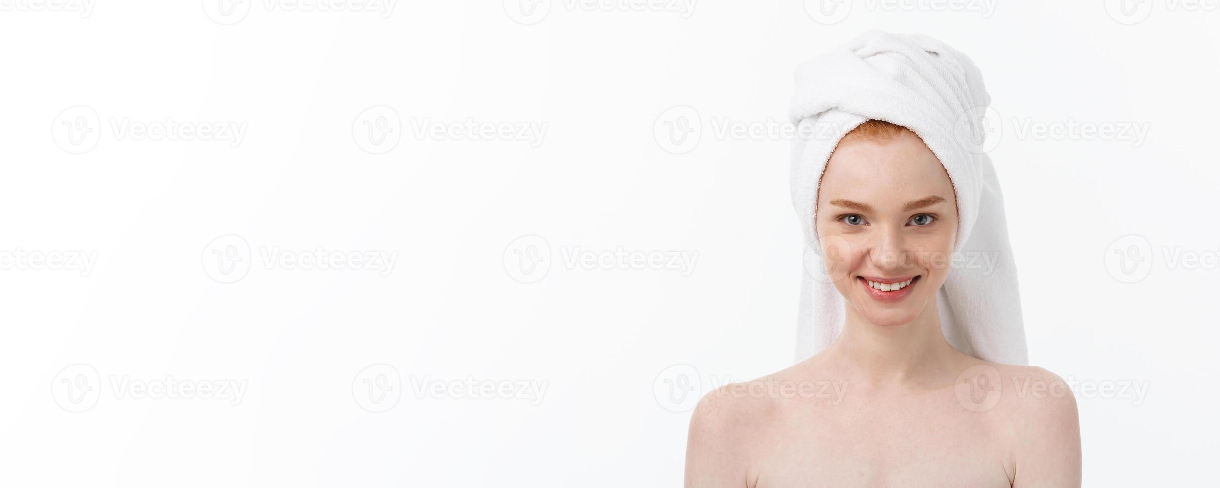 Surprised Beautiful Young Woman After Bath with A Towel On Her Head Isolated On white Background. Skin Care And Spa Theme. photo