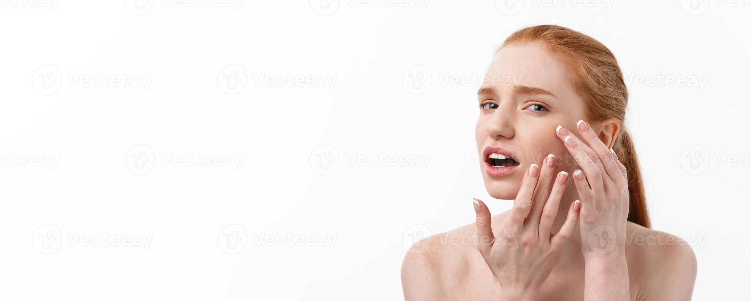 Young caucsian woman squeezes acne on the face of beauty photo