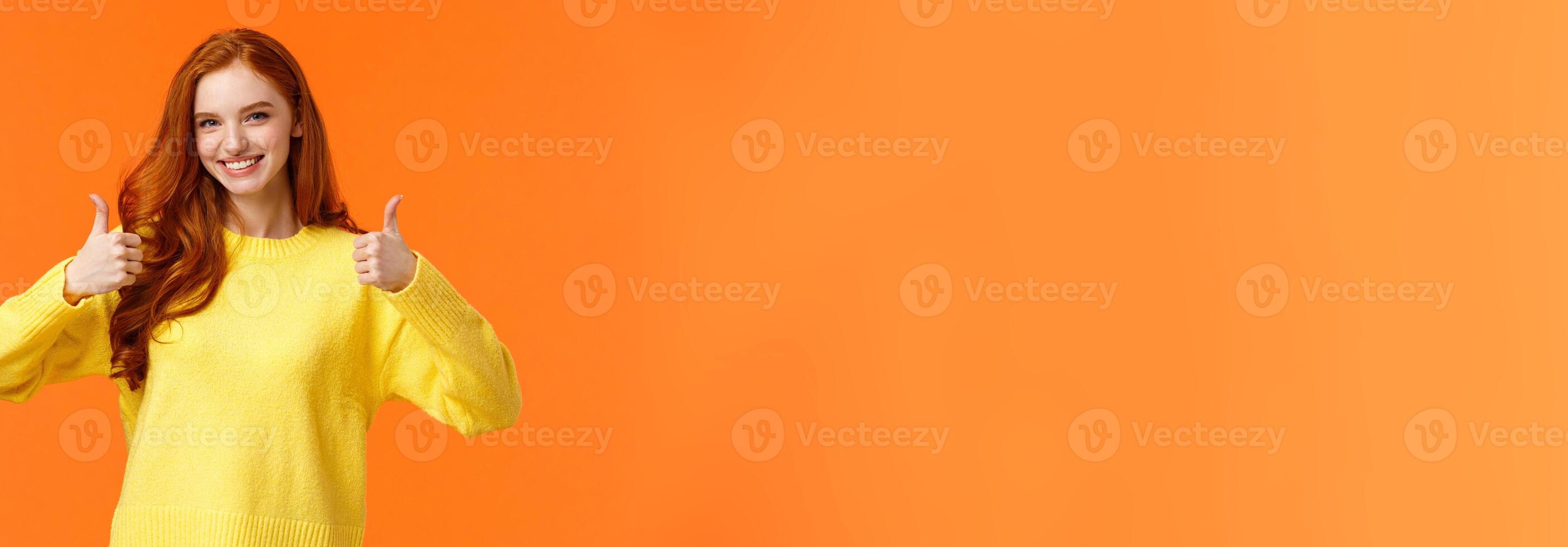 Confident and caring good-looking redhead sister rooting for sibling, saying yes, approving choice, recommend product, show thumbs-up and nod acceptance, smiling positive reply, orange wall photo