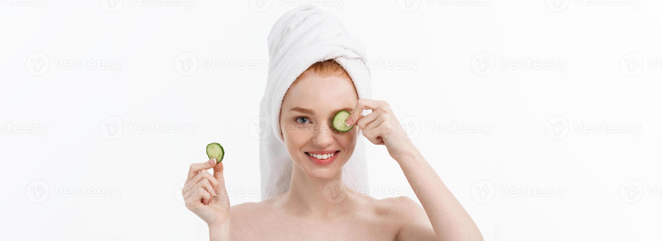 Attractive Young Woman with beautiful clean skin. White mask and cucumbers. Beauty treatments and cosmetology spa therapy. White background photo
